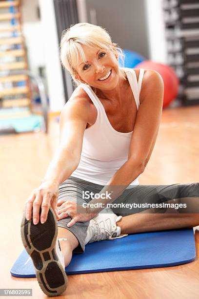 Senior Woman Stretching Exercising For Yoga Class Stock Photo - Download Image Now - Senior Women, 60-69 Years, Active Lifestyle