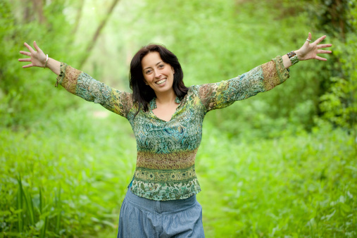 happy woman enjoy freedom in verdant woods