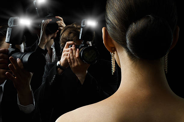 paparazzi Photographers are taking a picture of a film star diva stock pictures, royalty-free photos & images