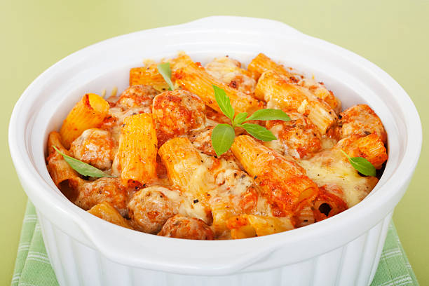 Pasta Bake with Italian Sausage Meatballs Casserole Rigatoni "Casserole with rigatoni pasta, tomato sauce, Italian sausage meatballs and cheese, hot and melting.  More pasta-" penne meatballs stock pictures, royalty-free photos & images