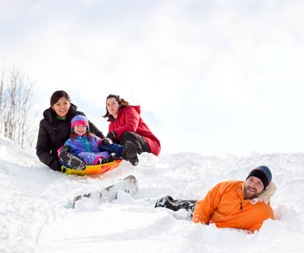 istock The whole family outdoors enjoying sledding in deep snow 176804669