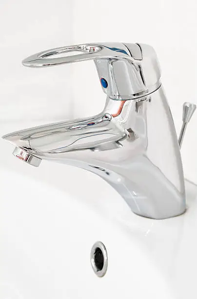 One chrome faucet in washbowl in bath room on white pile