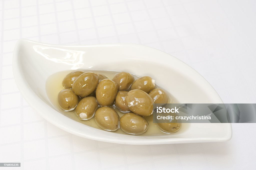 Olives stuffed with fetta cheese Dish of olives stuffed with fetta cheese, on white patterned tablecloth. Stuffed Olive Stock Photo