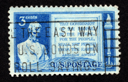 Antique stamp from the United States with an image and quote of/from Abraham Lincoln.