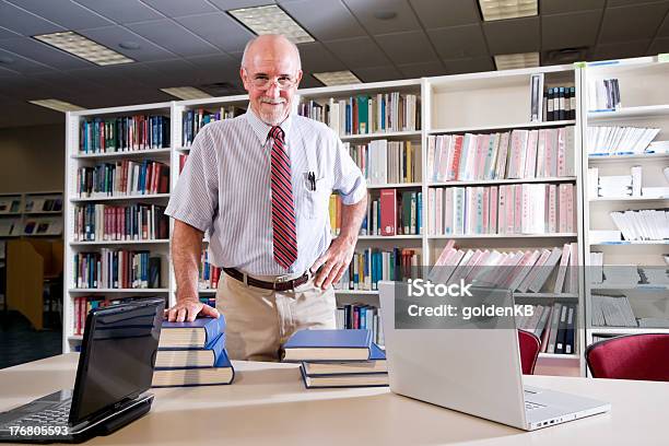 Portrait Of Mature Man At Library Table With Textbooks Stock Photo - Download Image Now