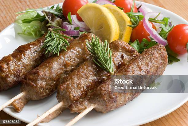 Four Lamb Kebabs Served With A Side Salad And Lemon Wedges Stock Photo - Download Image Now