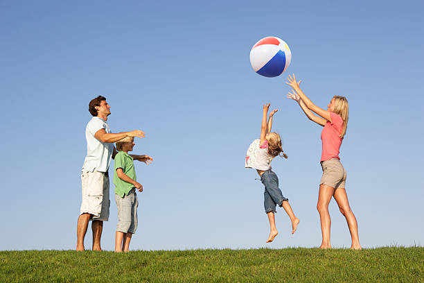 istock Young family playing in a field 176806277