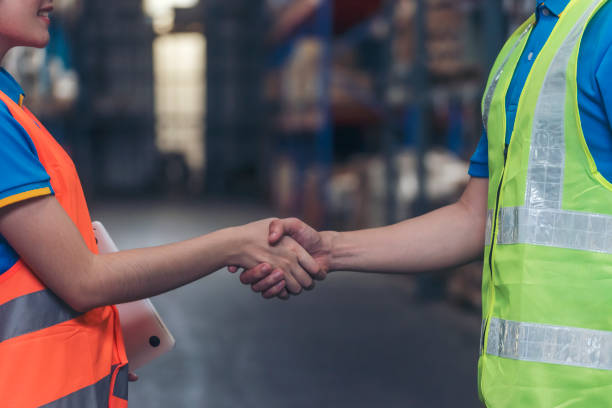 istock Close up warehouse worker shakehand together. Engineer man hands partnership. Diversity Coworker Men logistics Warehouse teams handshake. Multiracial Support team greeting person teamwork colleagues 1768063137