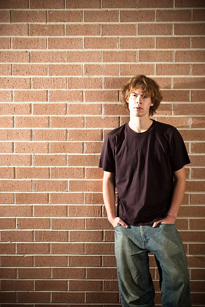 istock Young man stands with hands in pockets 176806337