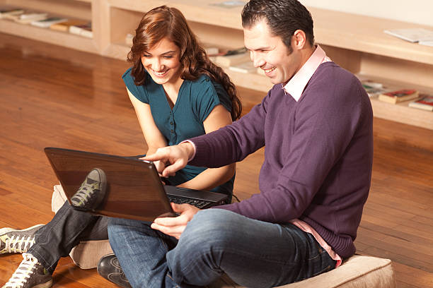 istock Happy couple with laptop on the floor 176806494