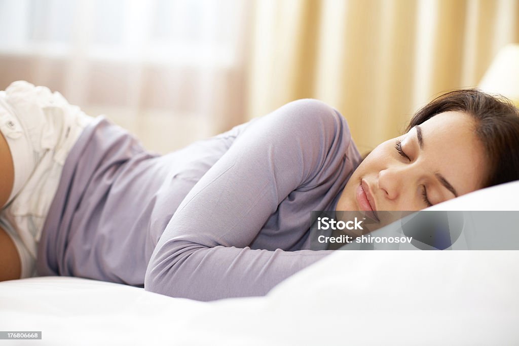 Peace Pretty girl lying on bed and having a nap Adult Stock Photo