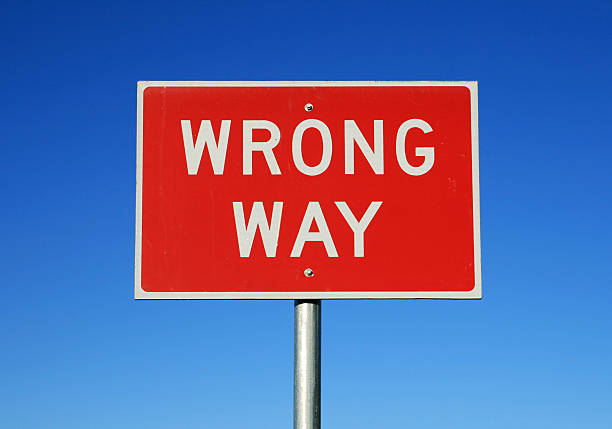 Red rectangular wrong way sign on blue background stock photo