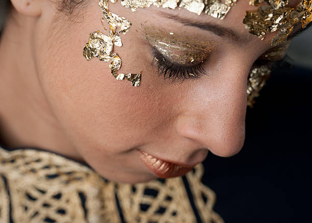 istock Gold Leaf Clad Performer Looking Downward in Reflective Moment 176808243