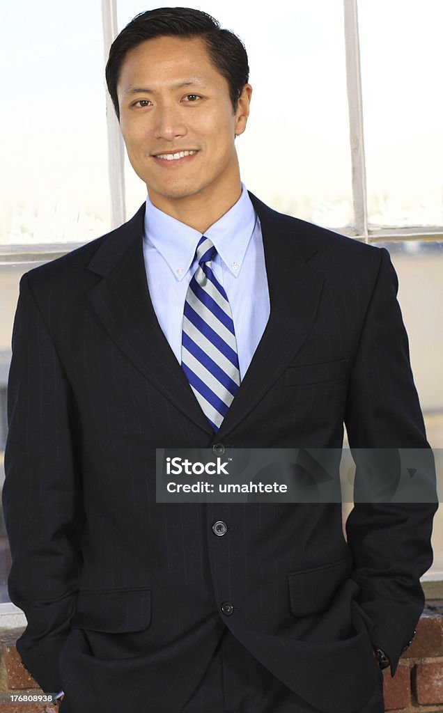 Asian businessman smiling Portrait of a young Asian businessman smiling Adults Only Stock Photo