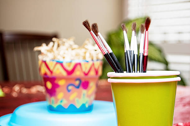 Artistic brushes close up. Watercolor paints in the background. Background with brushes and paints.