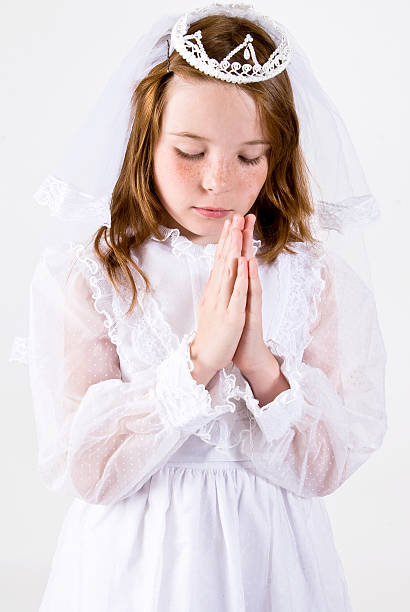 istock Young girl Praying in First Communion Attire 176809679
