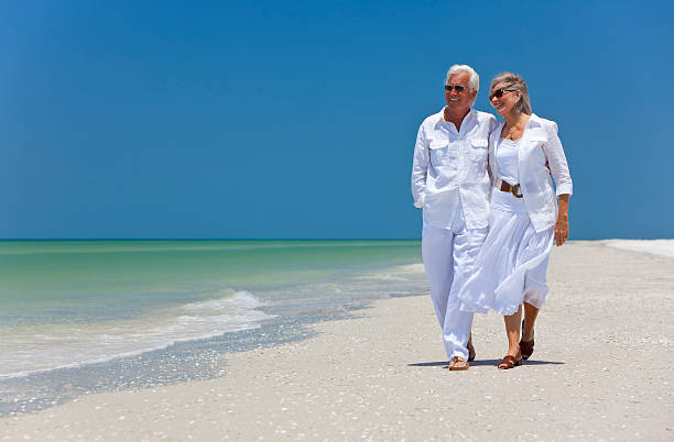 istock Happy Senior Couple Walking on A Tropical Beach 176809732