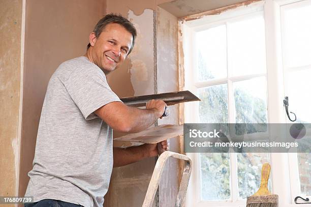 Plasterer Working On Interior Wall Stock Photo - Download Image Now - Plasterer, Wall - Building Feature, 40-49 Years