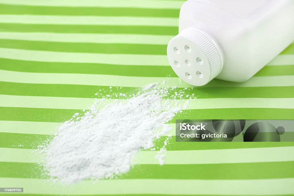 Spilled baby powder Spilled baby scented powder on striped green background with short depth of field Allergy Stock Photo