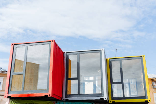 istock Sea containers are converted into a store, a panoramic window, a plastic profile, boutique construction. Box against the sky, colored containers. 1768102541