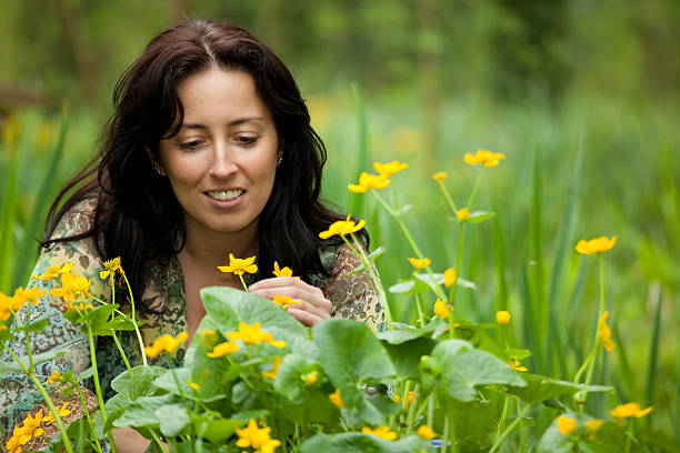 istock woman smelling flower 176810853