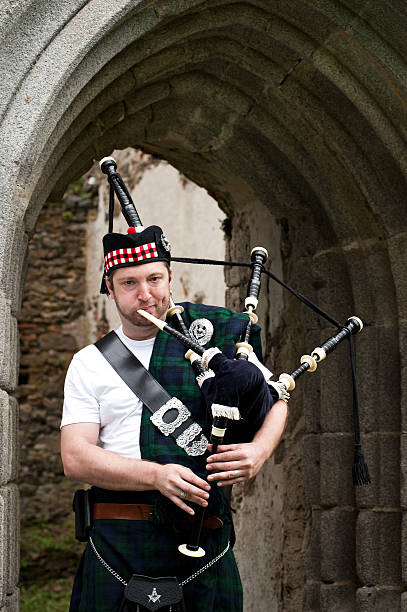 istock Bagpiper on a medieval Location 176811719