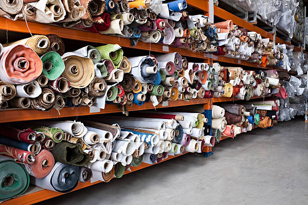 Shelves of miscellaneous fabric rolls stock photo