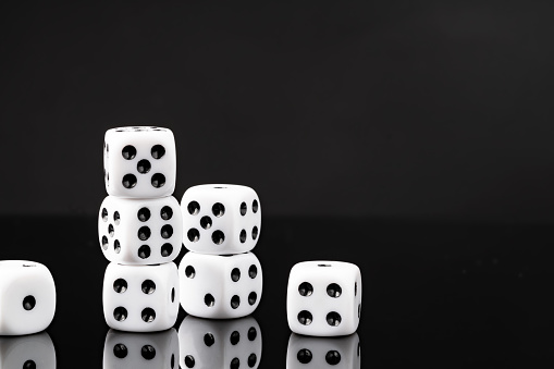 White dice on black background studio shot close up