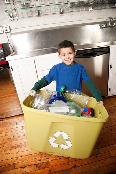 istock Go Green: Hispanic Little Boy Holding Full Recycling Bin 176814066