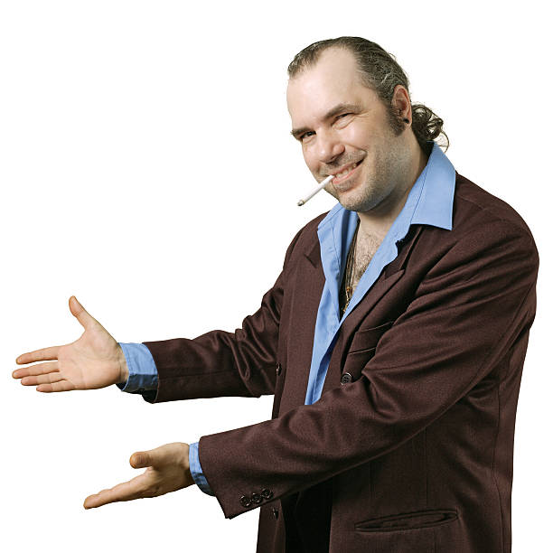 Sleazy salesman pointing "A sleazy car salesman, Con man, retro suit wearing man with happy smile showing you his deals." sleaze stock pictures, royalty-free photos & images