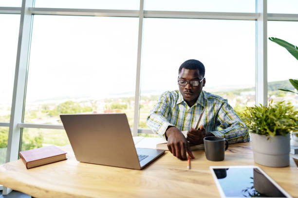 istock Young african man working on laptop in office 1768146971