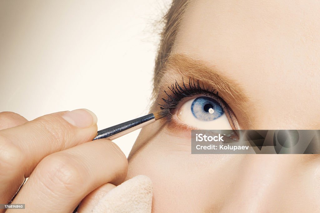 Close-up of a female applying make-up Studio shot 20-24 Years Stock Photo