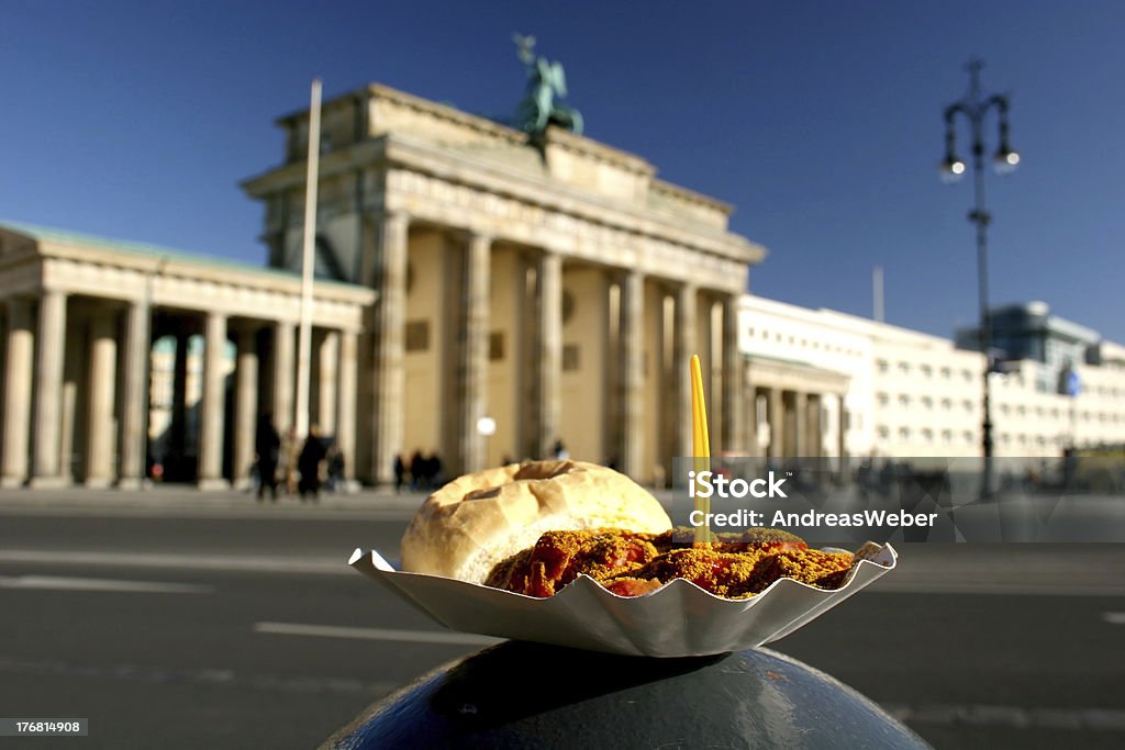 Currywurst and Brandenburg Gate Berlin delicacy Currywurst in front of the landmark Brandenburg Gate, Germany Berlin Stock Photo