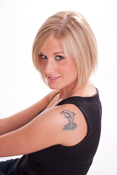 Young woman wearing blank vest. Wood wall background.