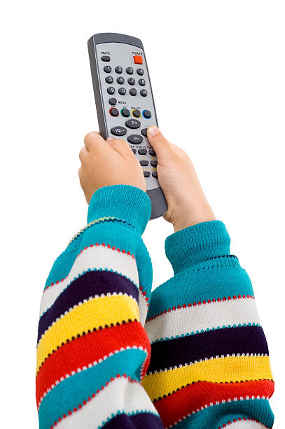 children's hands with a remote control stock photo