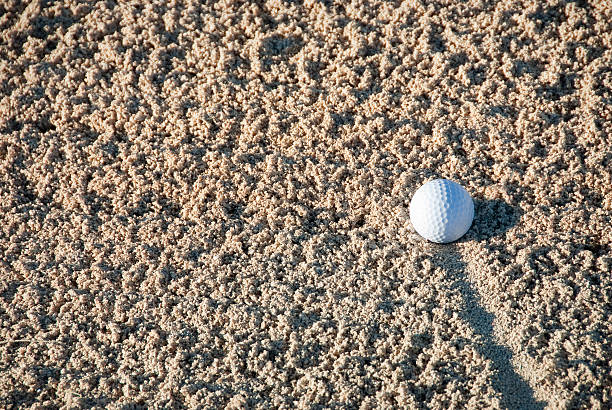 istock White Golf Ball in a Sand Trap 176815705