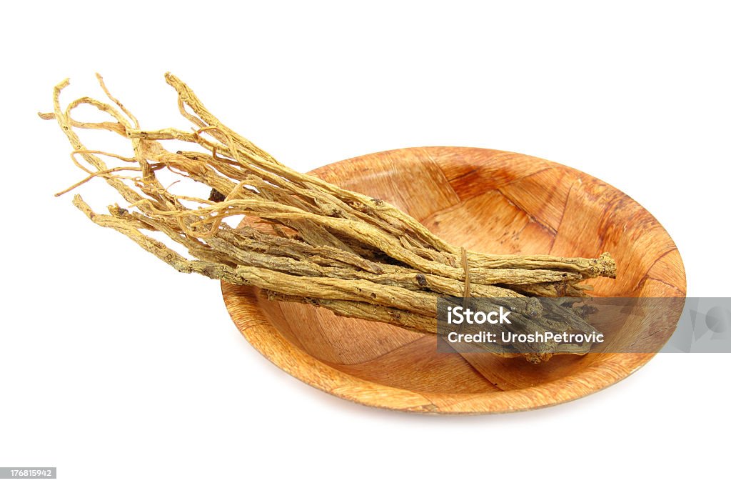 Ginseng root on a wooden plate This is a ginseng root.  Alternative Medicine Stock Photo