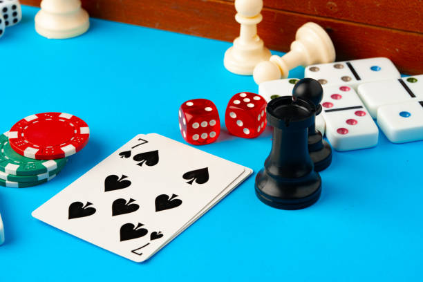 istock Items for playing chess, poker and domino on blue background studio shot 1768165736