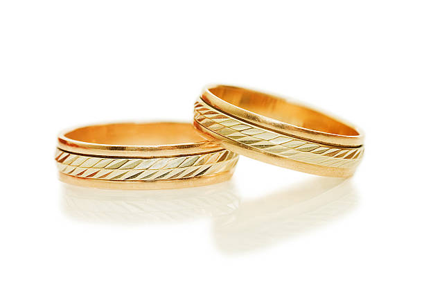 istock Two golden wedding rings. Isolated on white 176816735