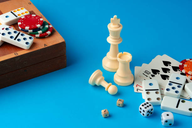 istock Items for playing chess, poker and domino on blue background studio shot 1768170424
