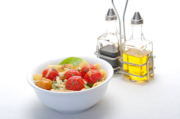 Rigatoni with tomato and basil stock photo