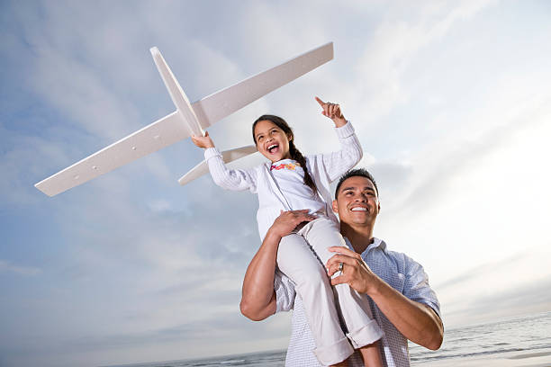 istock Hispanic dad playing holding girl high on shoulder 176817102