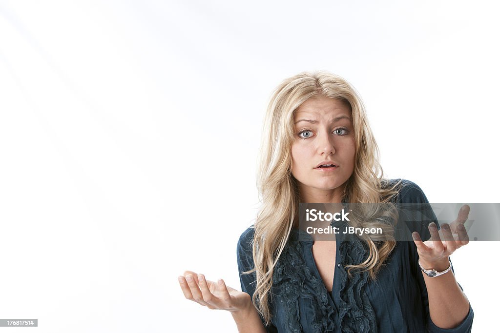 Caucasian Young Woman with Questioning Expression Headshot of a caucasian young woman with her hands up and a questioning expression on her face. She has long blond hair and blue eyes. 20-24 Years Stock Photo
