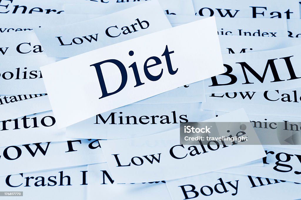 Paper cutout of the word Diet above other related words A conceptual look at diet and different types of diet. Which will you try? Blue Stock Photo