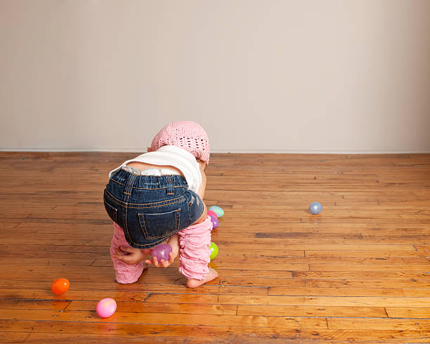 istock Toddler Girl Picking Up Easter Eggs 176817924