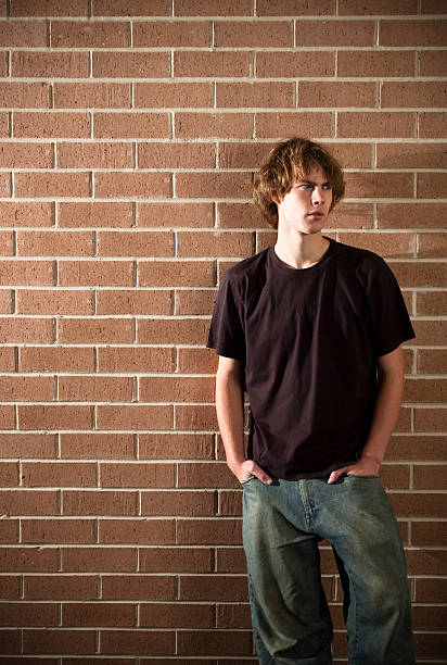 istock Young man stands near a wall 176818499