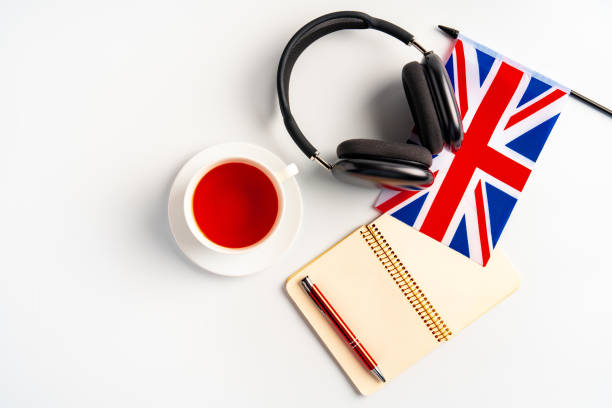 istock Notepad with British flag and headphones on white background. English language audio courses educational concept 1768187659