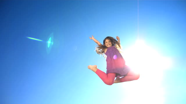 HD Super Slow-Mo: Cheerful Girl Jumping In The Air