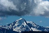 dense clouds above mountain top in altai russia