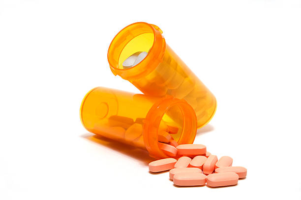 Prescriptions spilling Two bottles of prescription pills.  Files sizes up to XXXL available. statin photos stock pictures, royalty-free photos & images